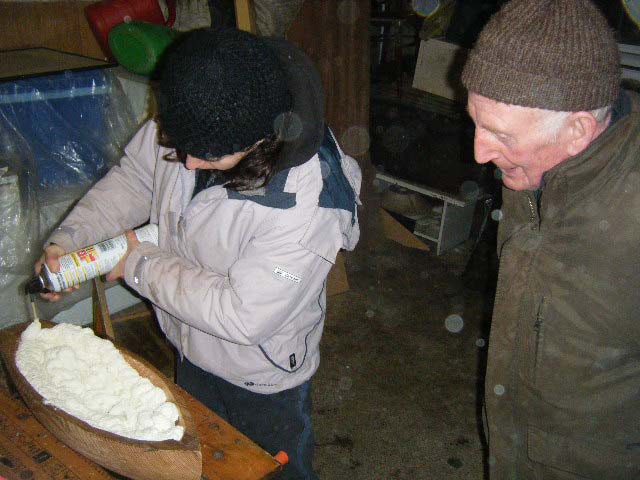 Loughie watches as Marianne applies the expanding foam. Photo: SR